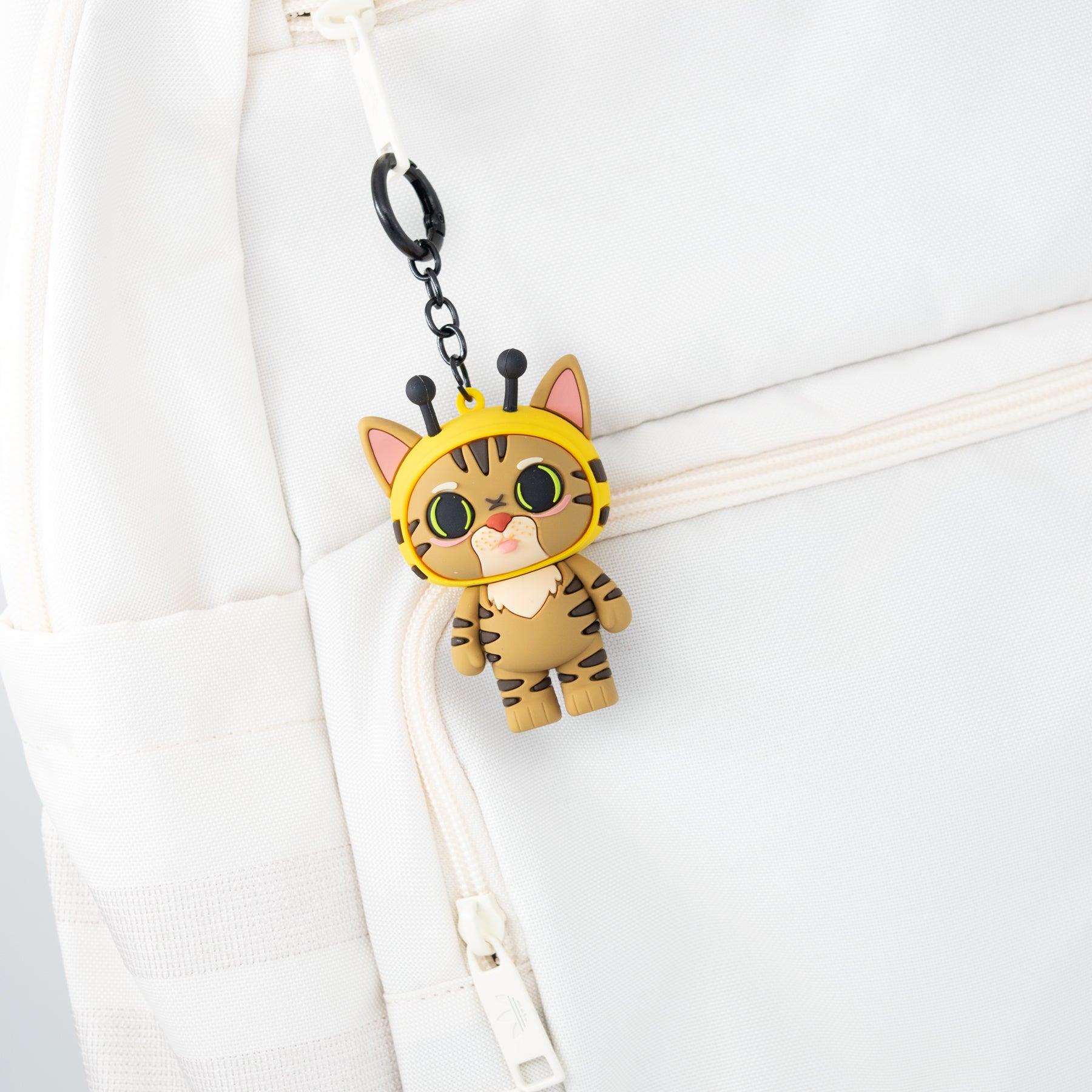Cat bag charm keychain featuring Gumbus cat from TUFCAT Pocket Paws on backpack